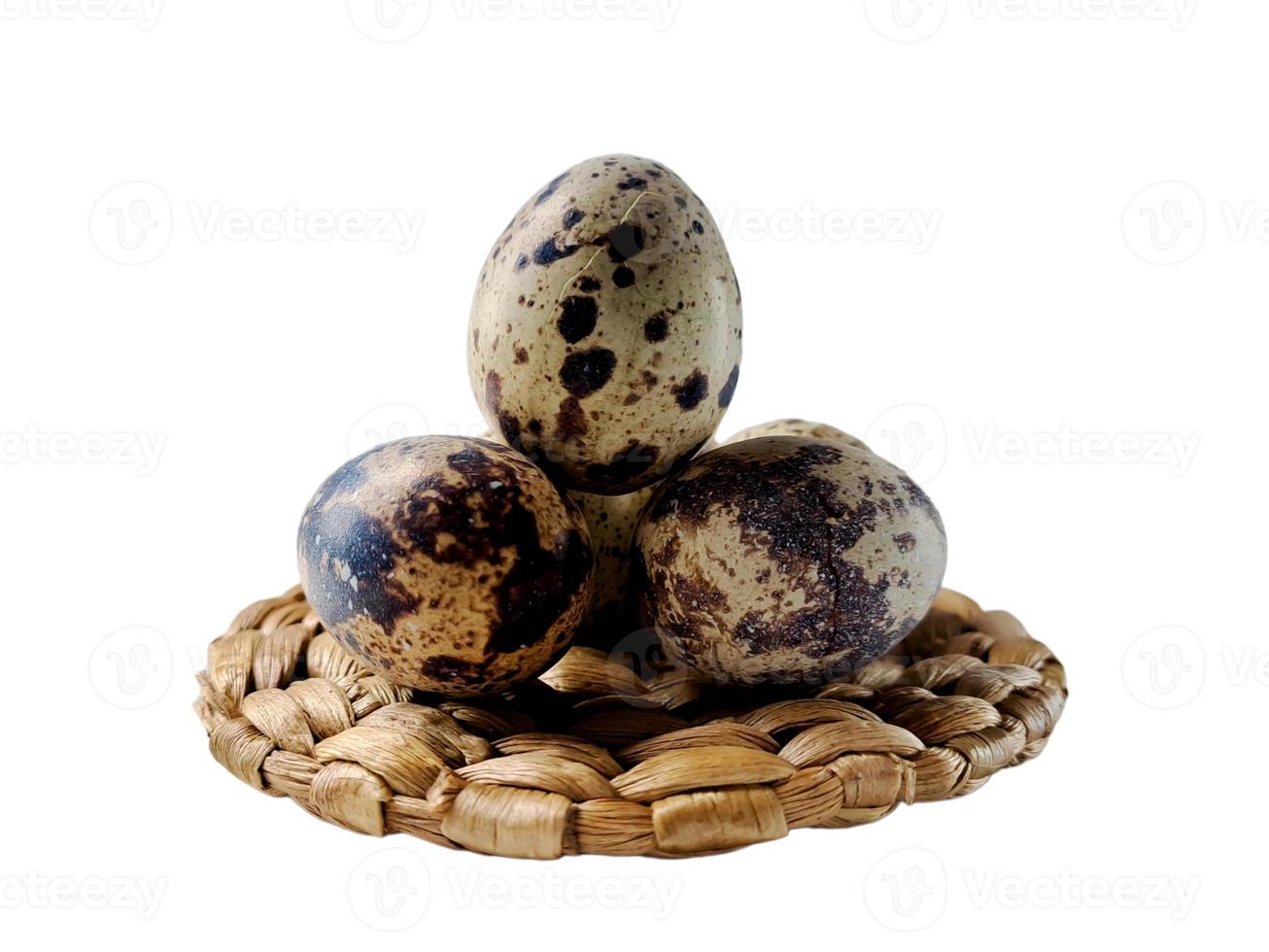 Quail eggs from quail, a collection of quail eggs on a wooden plate with isolated white background photo