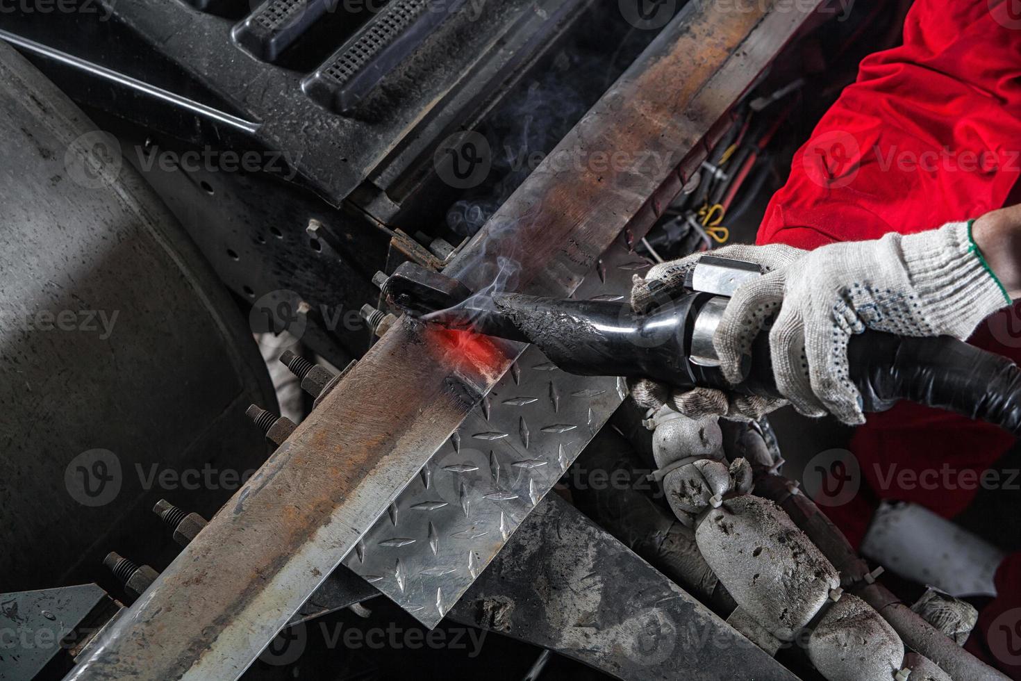 mechanic heats the metal photo