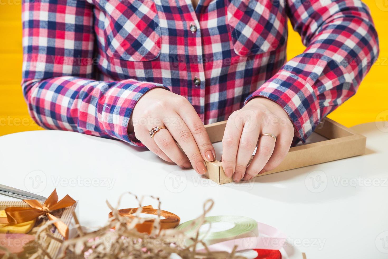 confectioner  packs boxes photo