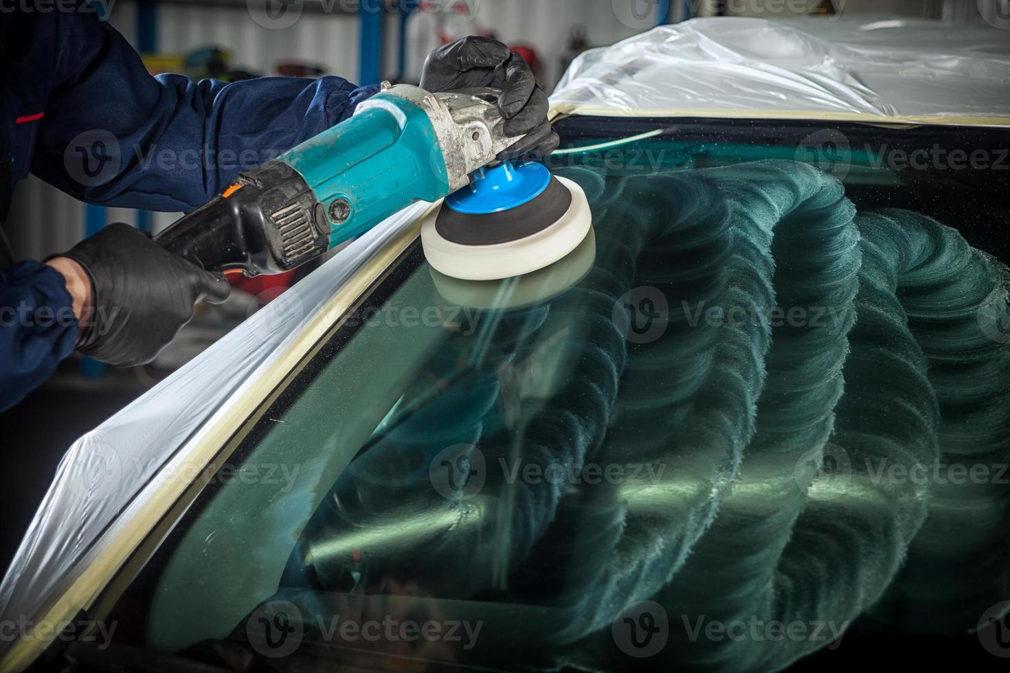 MAn polishes the front glass photo