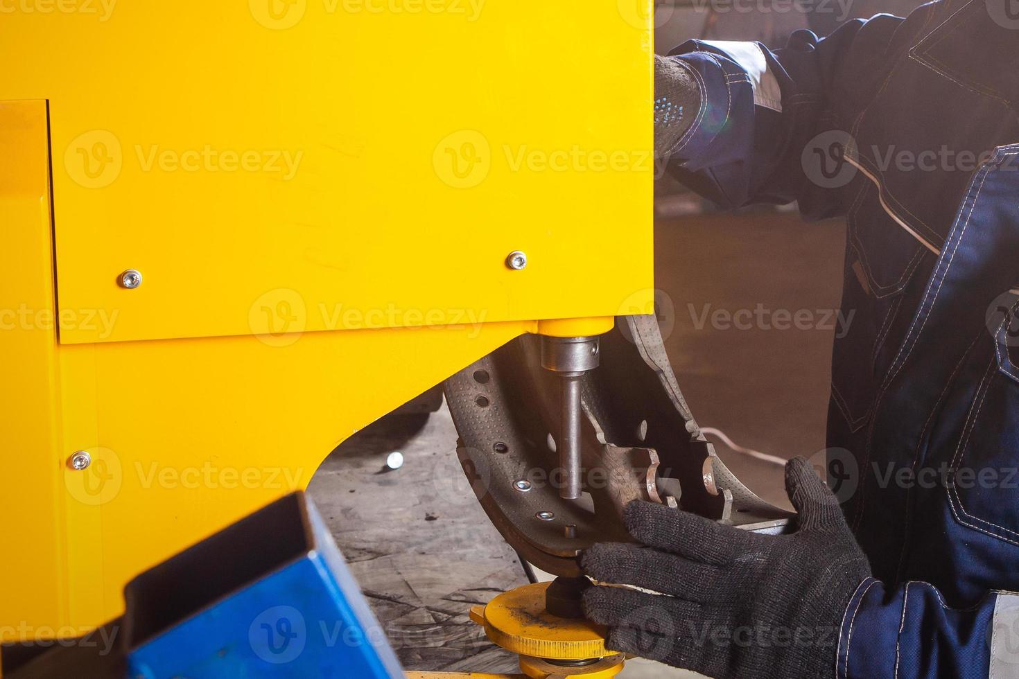 A close-up of a man fitter riveting brake photo