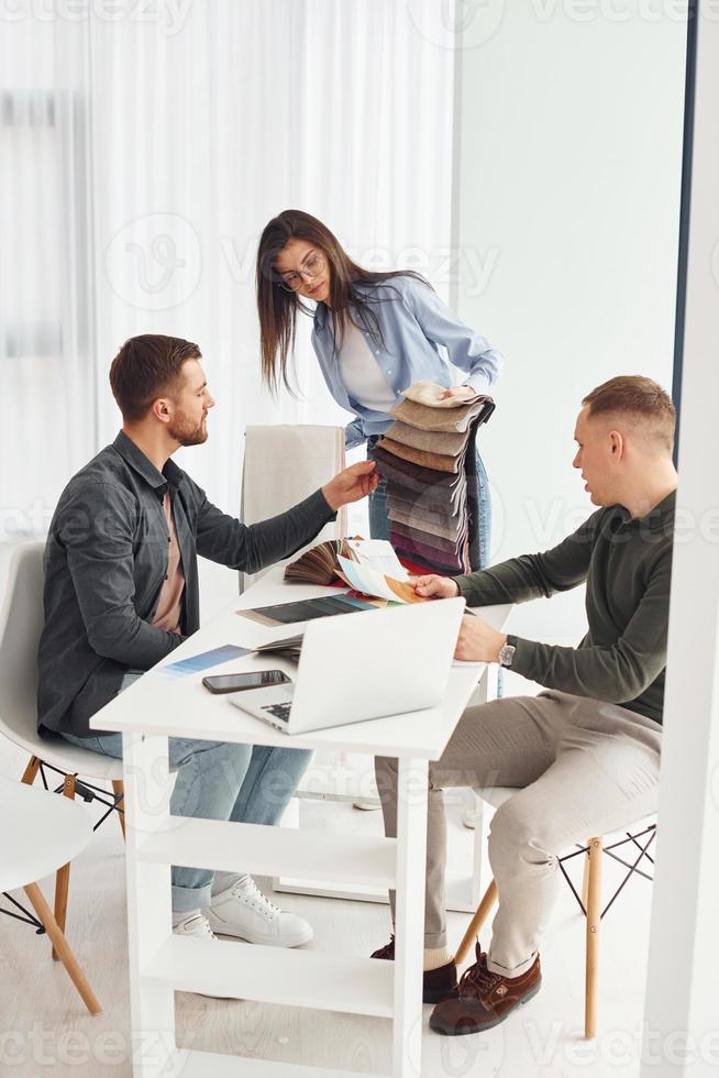 Group of people works in the office by sitting by the table photo