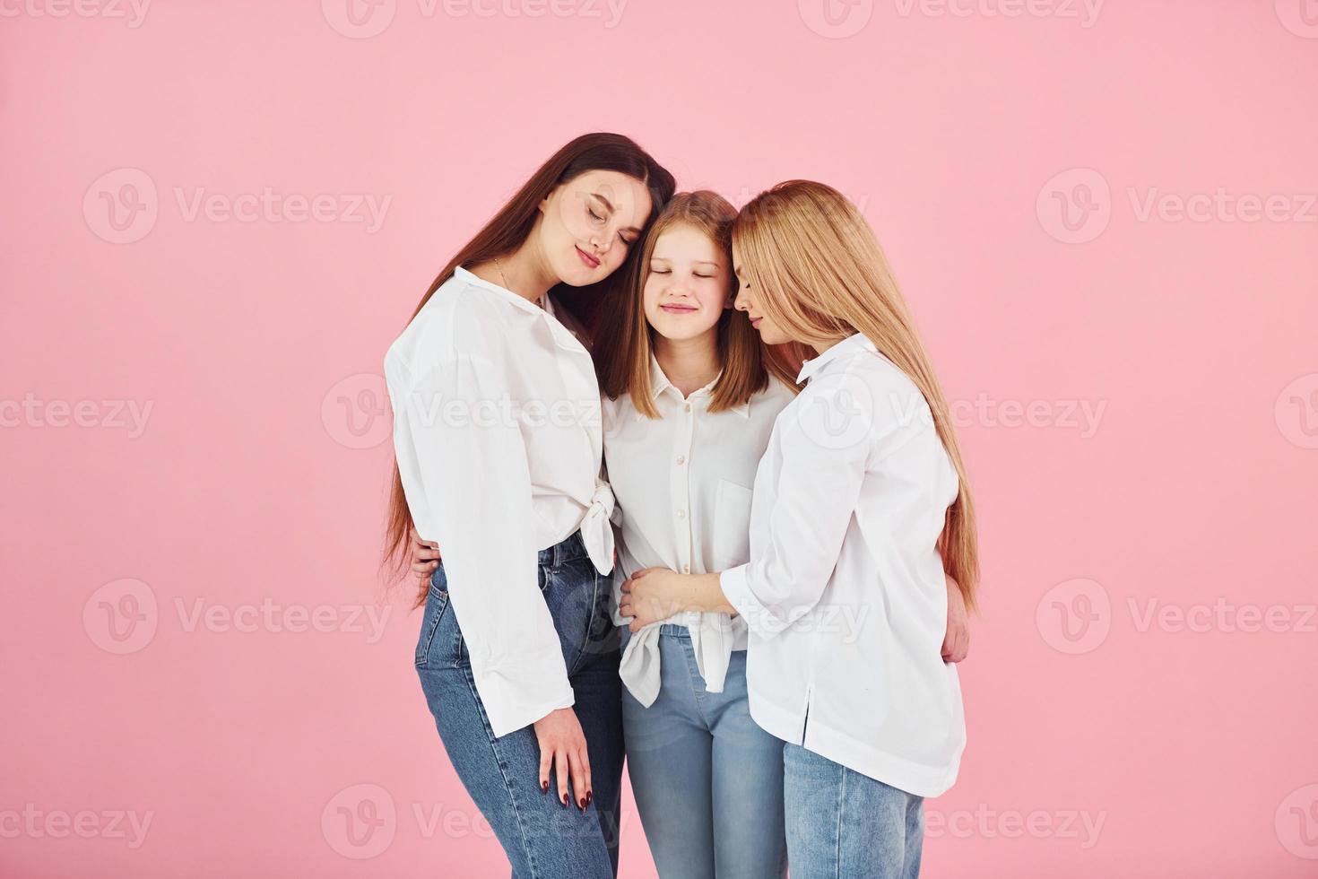 Young mother with her two daughters is in the studio photo