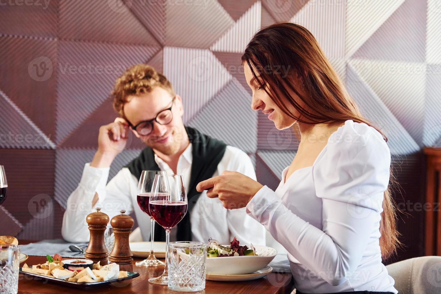 Man in glasses is with woman. Indoors of new modern luxury restaurant photo