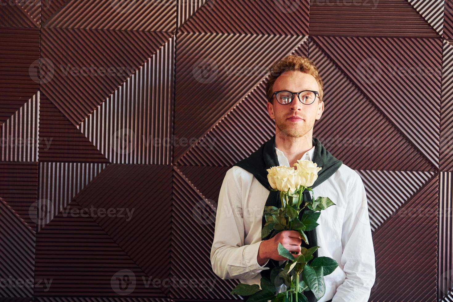Man holds flowers. Indoors of new modern luxury restaurant photo