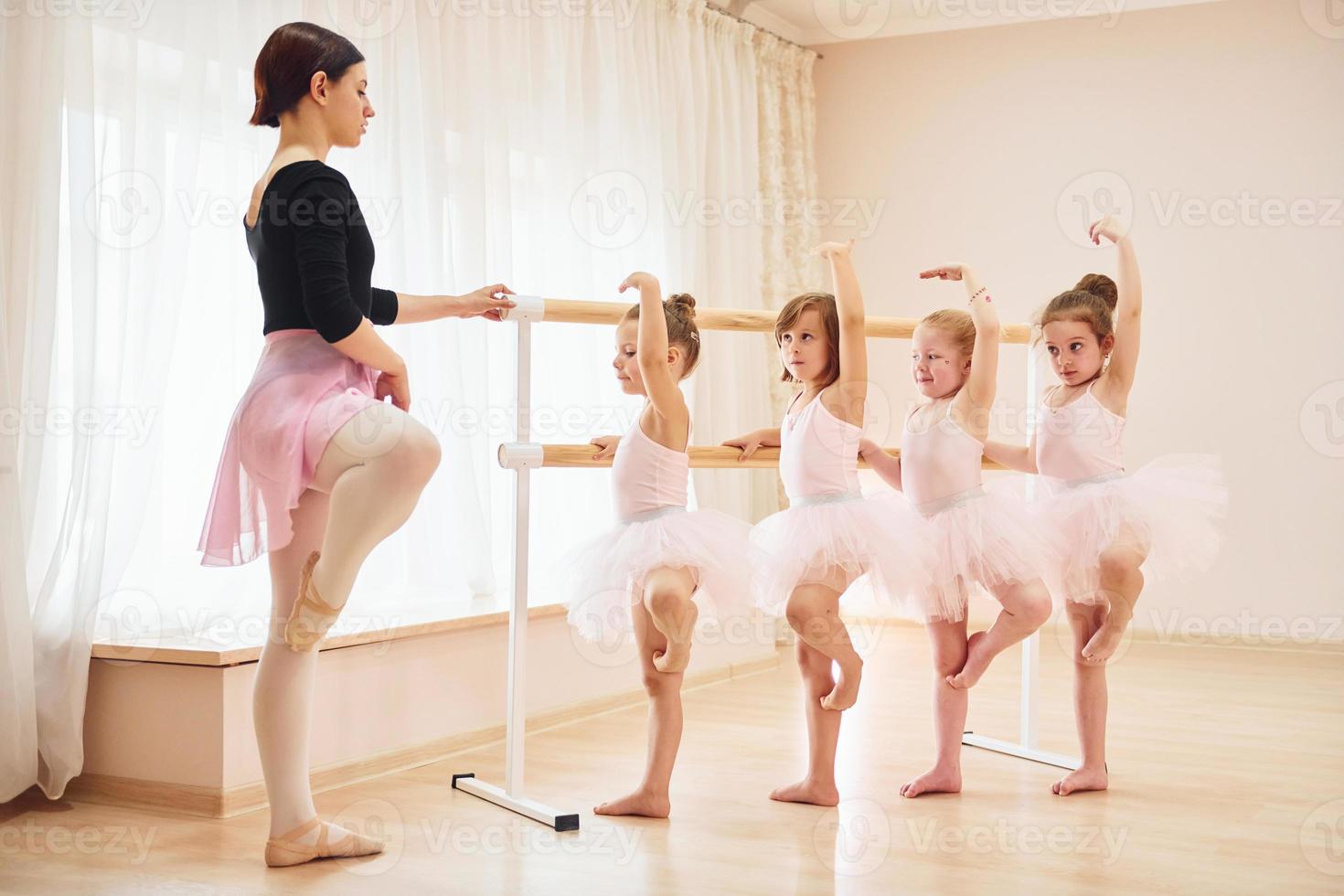 Practicing pose. Little ballerinas preparing for performance photo