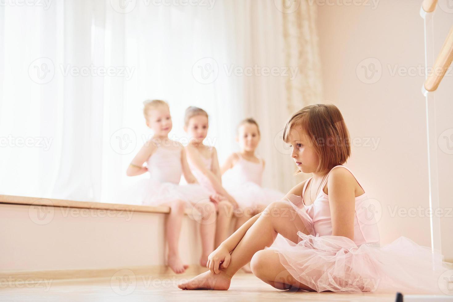 Practicing on the floor. Little ballerinas preparing for performance photo