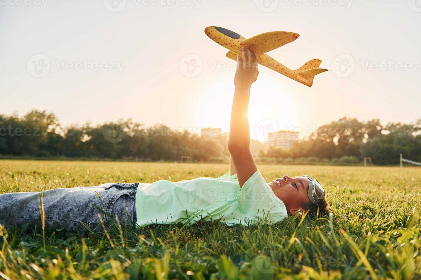 African american kid have fun in the field at summer daytime photo