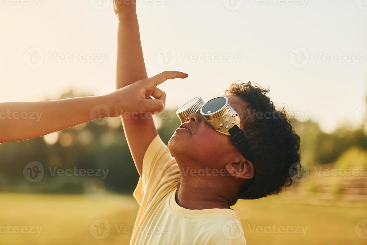 At summer daytime together. Two african american kids have fun in the field photo