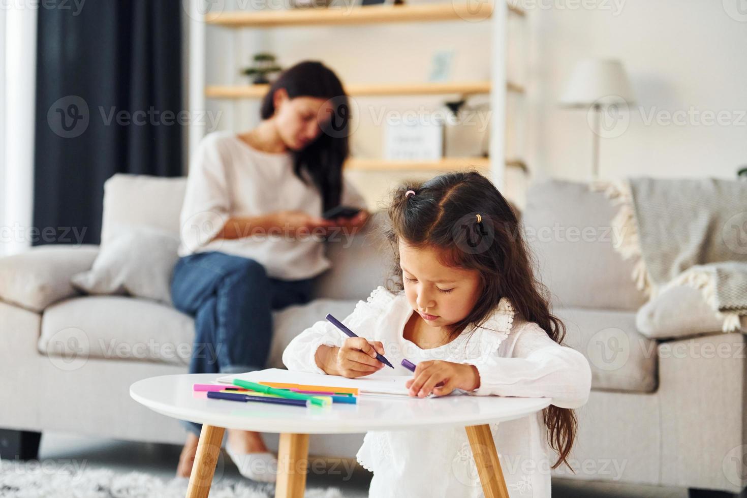 Modern design. Mother and her daughter spending time together at home photo