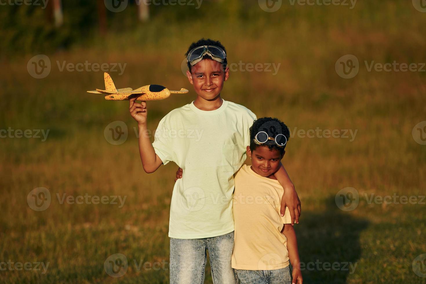 At summer daytime together. Two african american kids have fun in the field photo