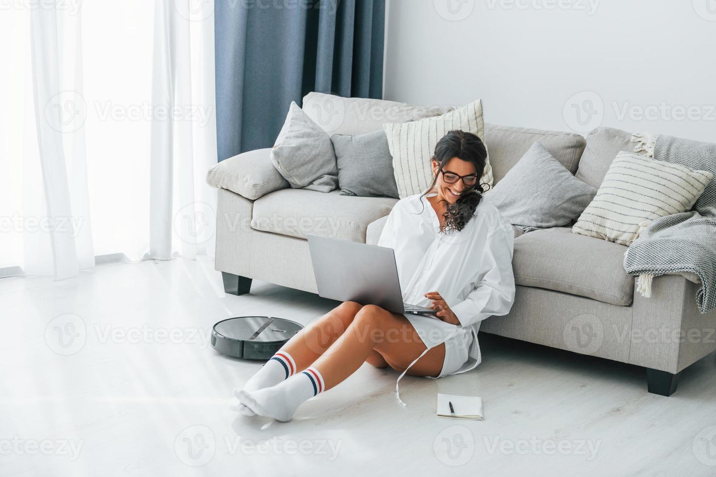 Freelance work. Woman in casual clothes is indoors at home photo