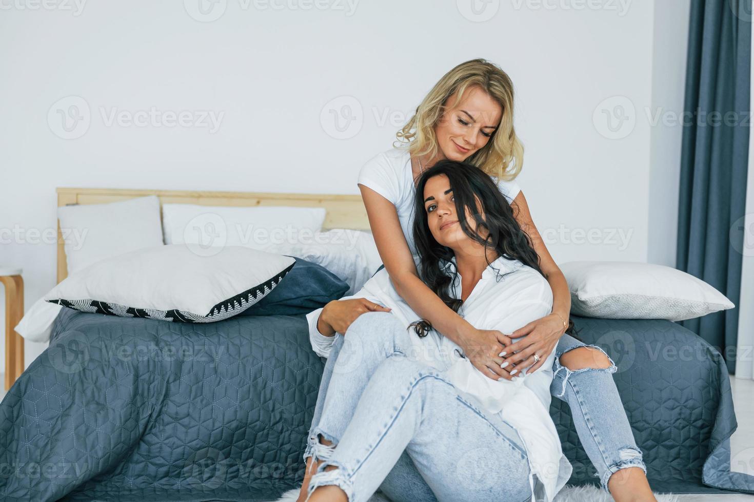 Embracing each other. Two women is together at home photo