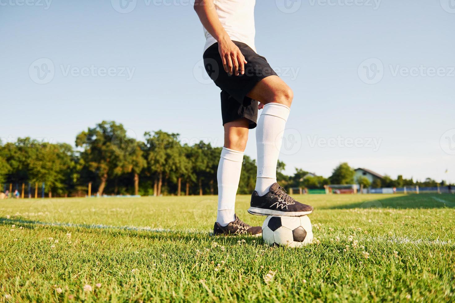 Sunny daytime. Young soccer player have training on the sportive field photo