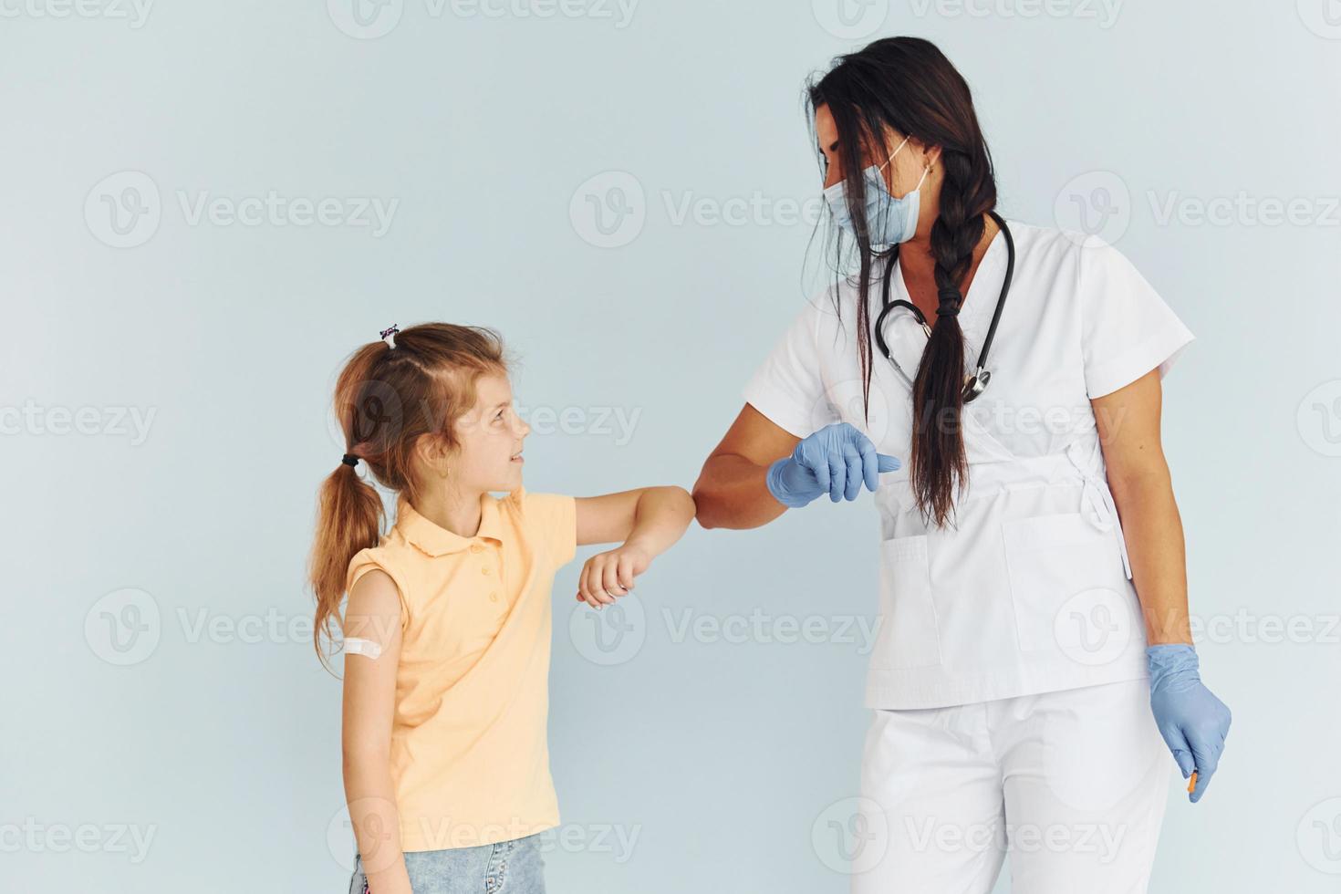 Procedure is done. Doctor in uniform making vaccination to the patient photo