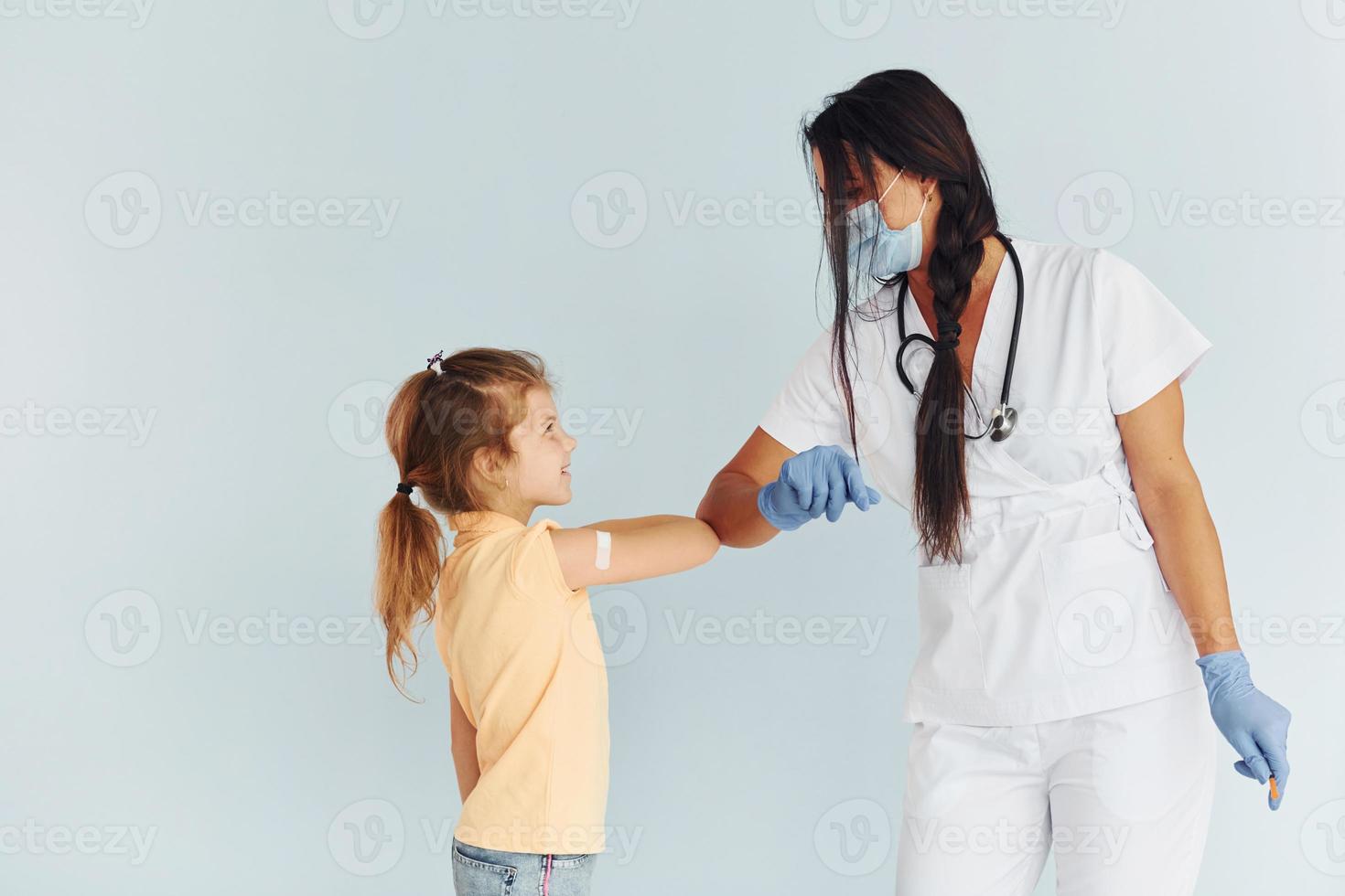 Procedure is done. Doctor in uniform making vaccination to the patient photo