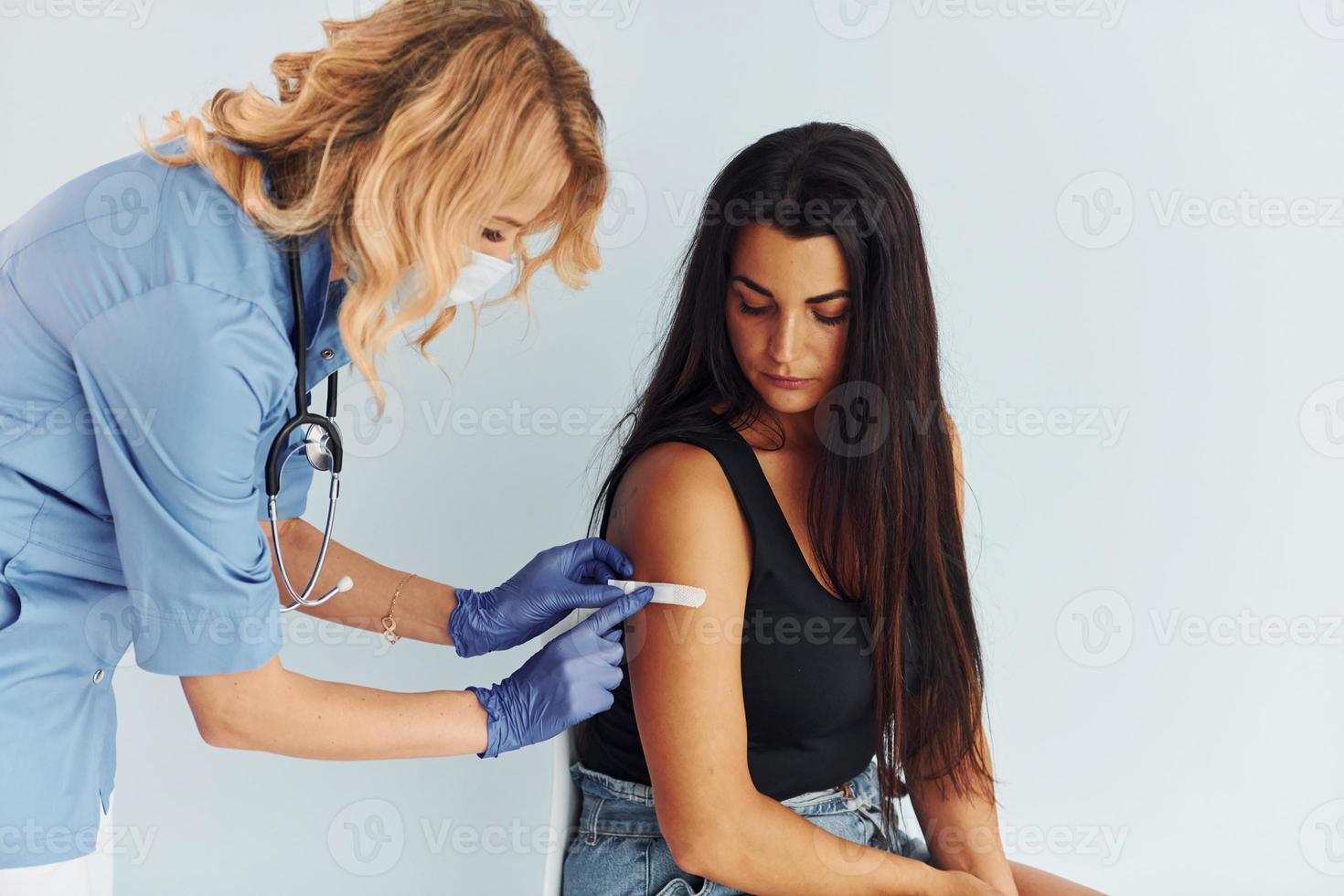 Succesfull procedure. Doctor in uniform making vaccination to the patient photo