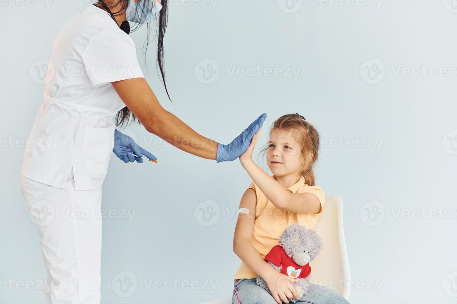Procedure is done. Doctor in uniform making vaccination to the patient photo