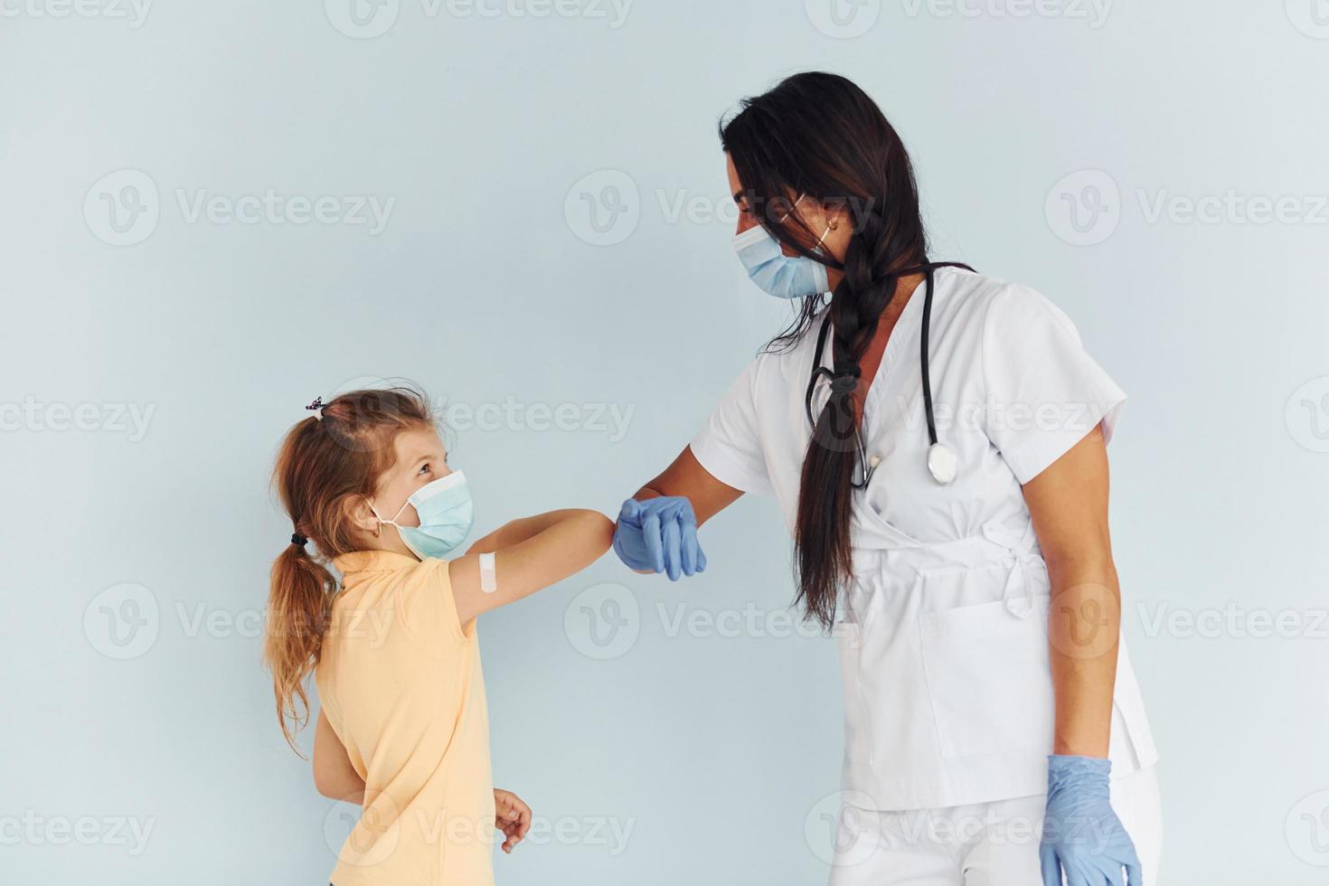 Procedure is done. Doctor in uniform making vaccination to the patient photo
