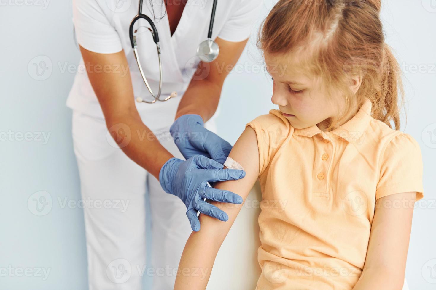 Professional occupation. Doctor in uniform making vaccination to the patient photo