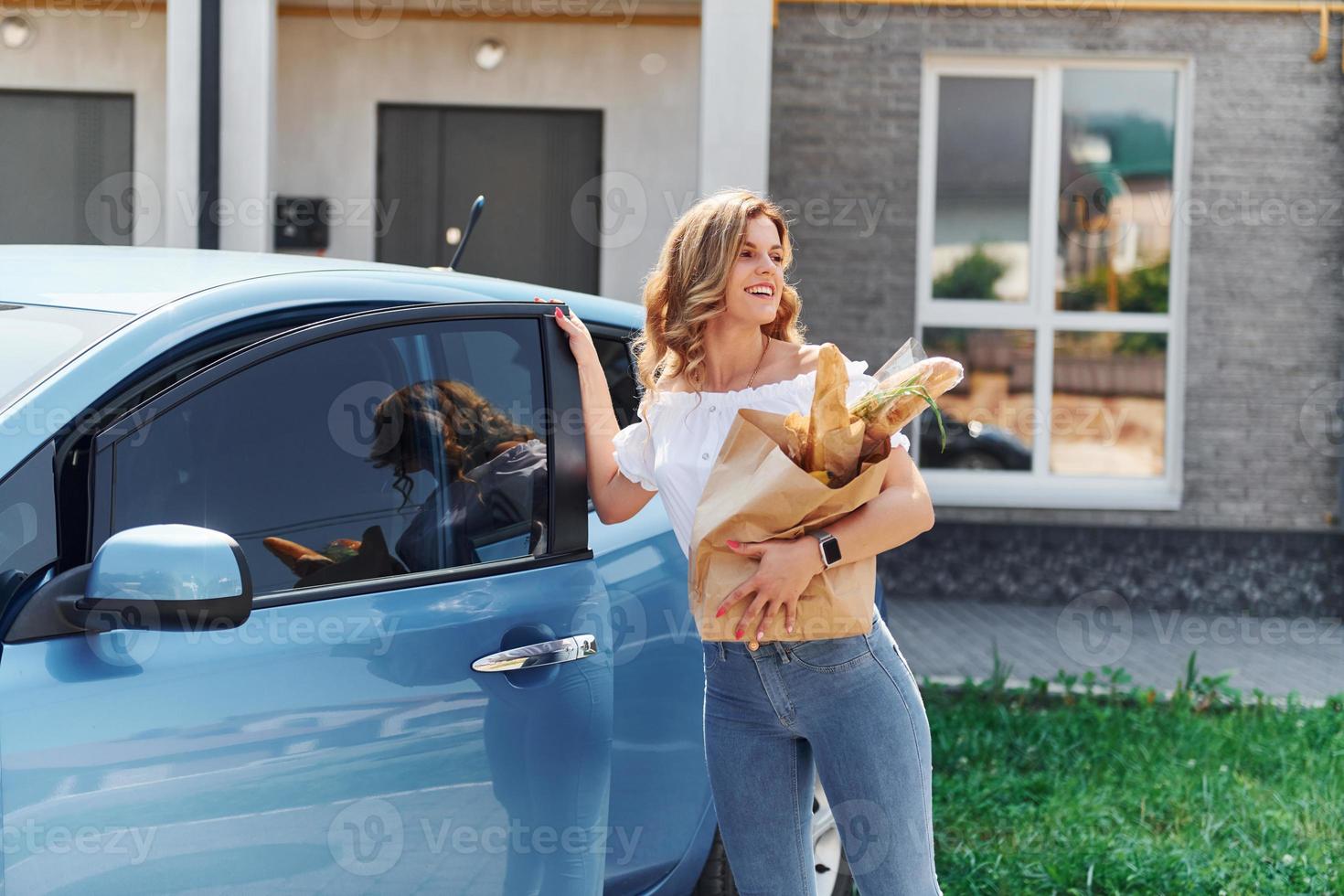 After shopping. Young woman in casual clothes with her electromobile outdoors at daytime photo