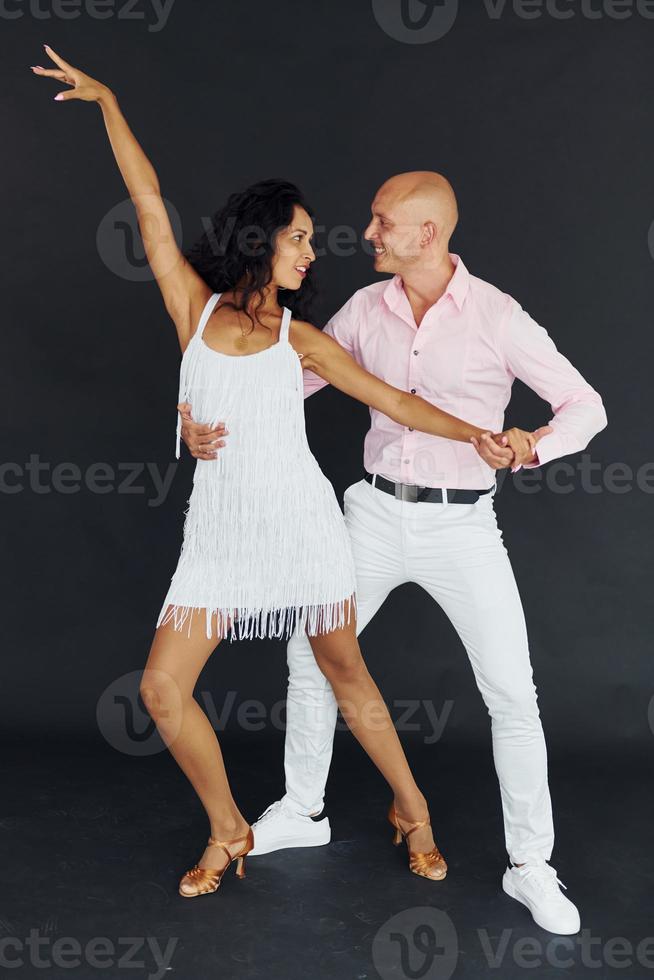 Dancing in the studio. Cheerful couple is together indoors photo