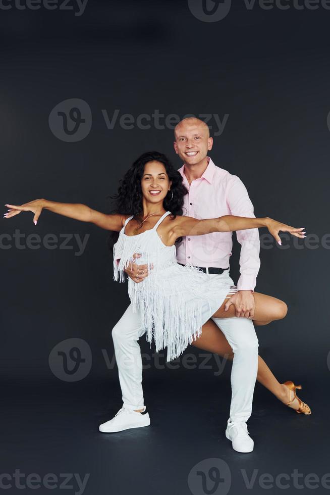 Dancing in the studio. Cheerful couple is together indoors photo