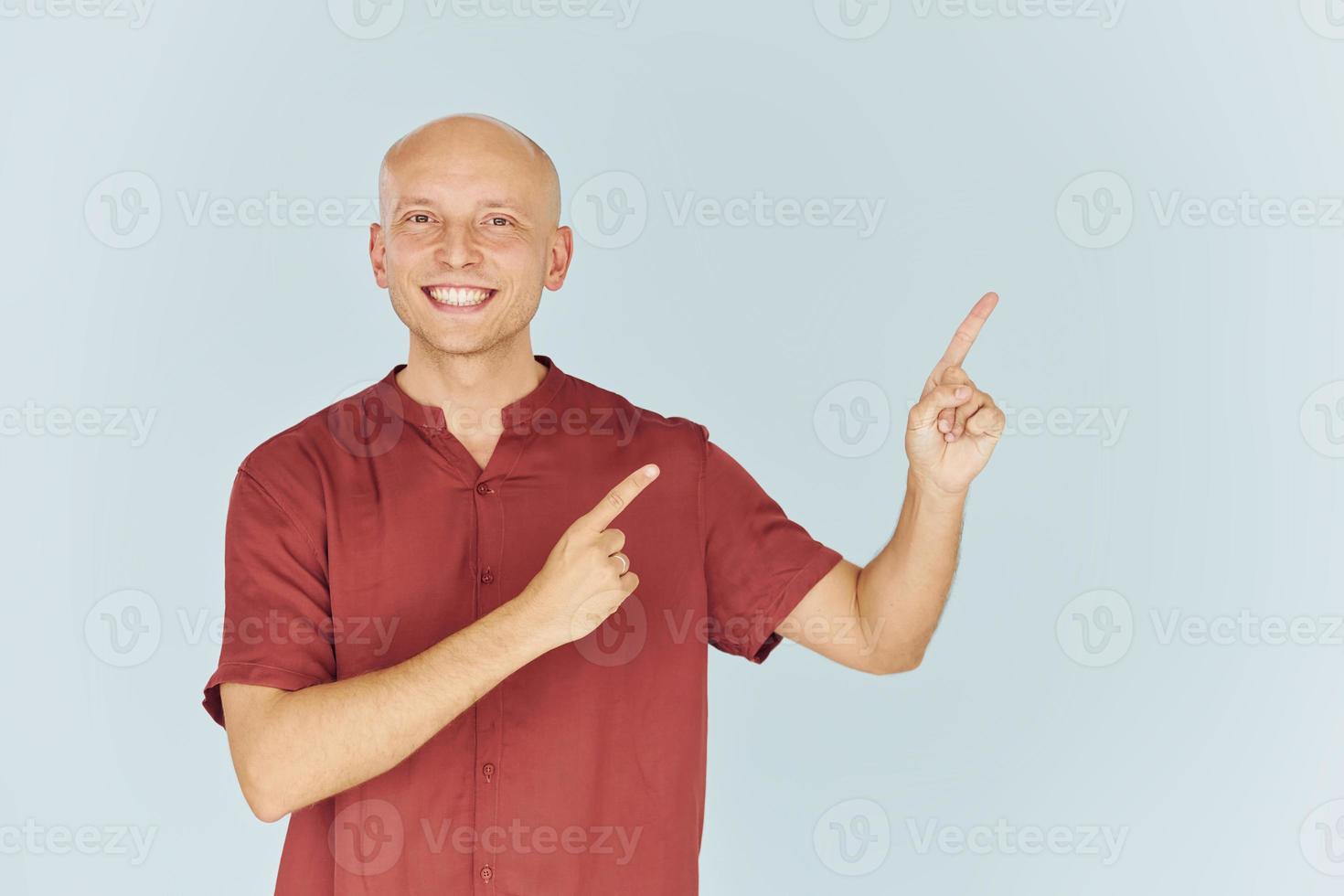 Man in red casual shirt is standing against white background photo