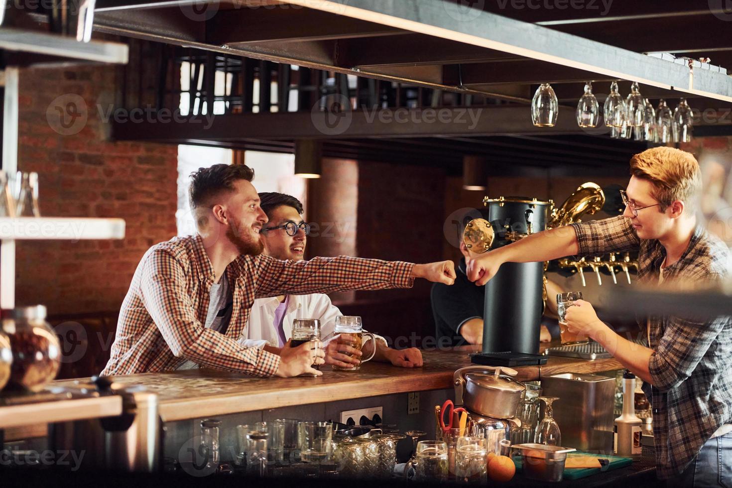 Having fun. People in casual clothes sitting in the pub photo