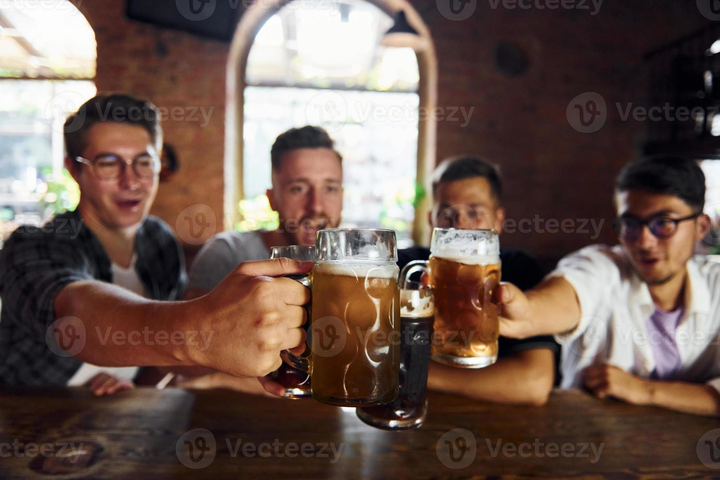 Drinking beer. People in casual clothes sitting in the pub photo