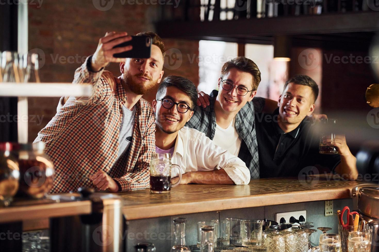 Having fun. People in casual clothes sitting in the pub photo