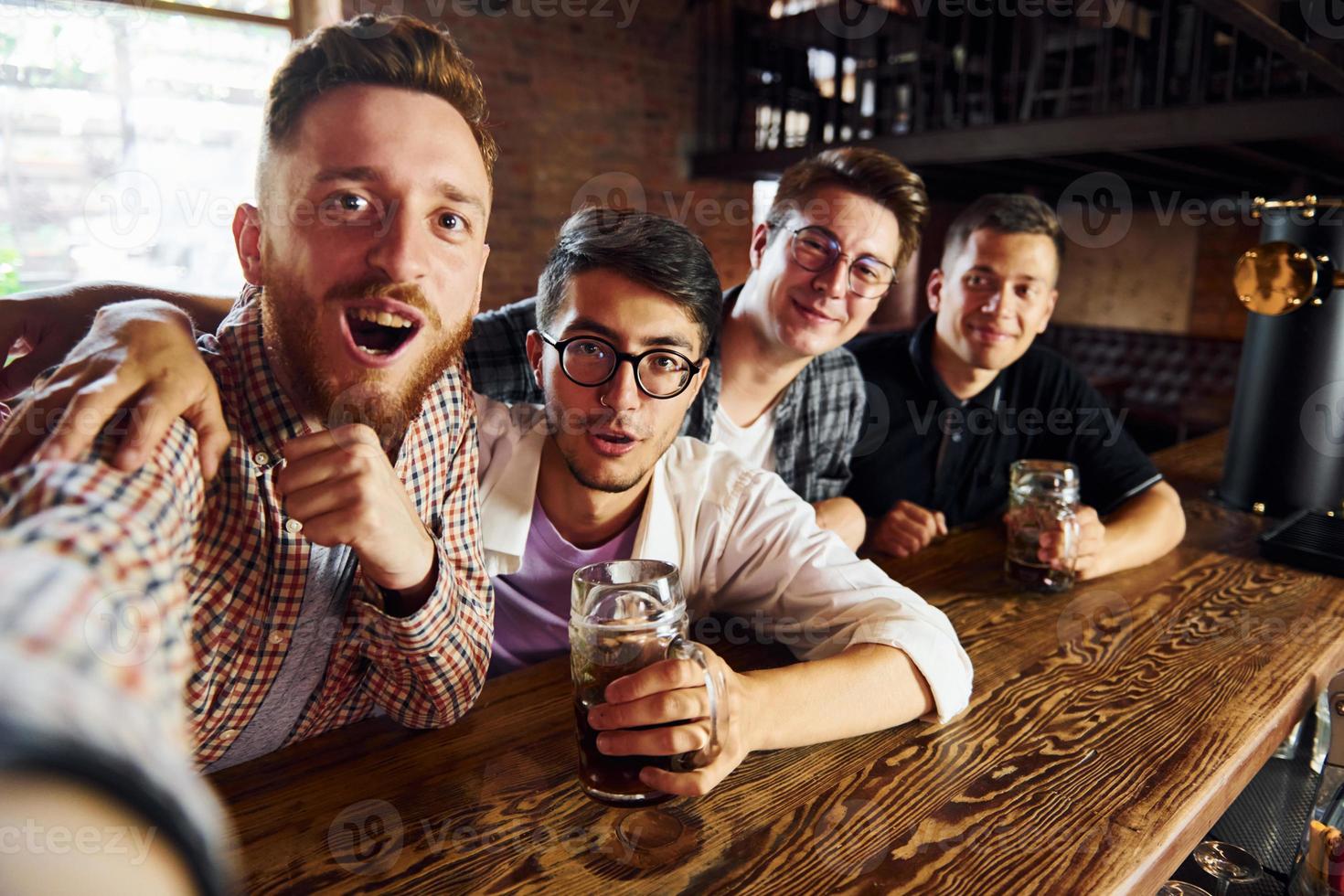 Having fun at weekend. People in casual clothes sitting in the pub photo