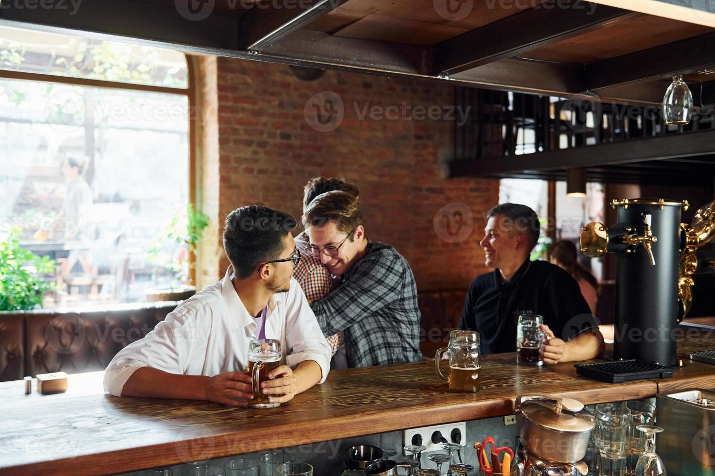 At daytime. People in casual clothes sitting in the pub photo