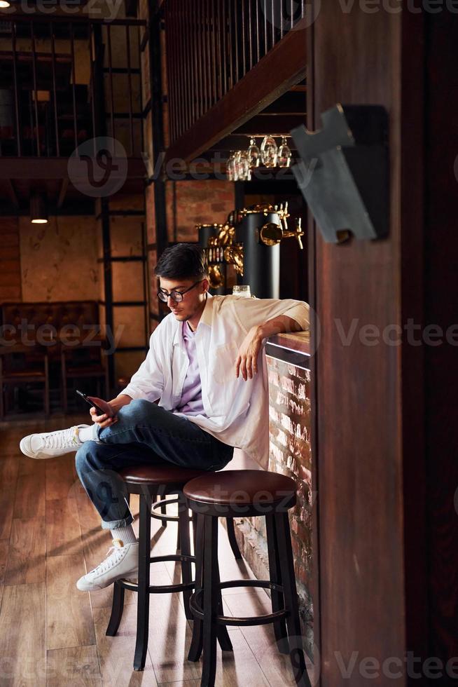 One person. Man in casual clothes sitting in the pub photo