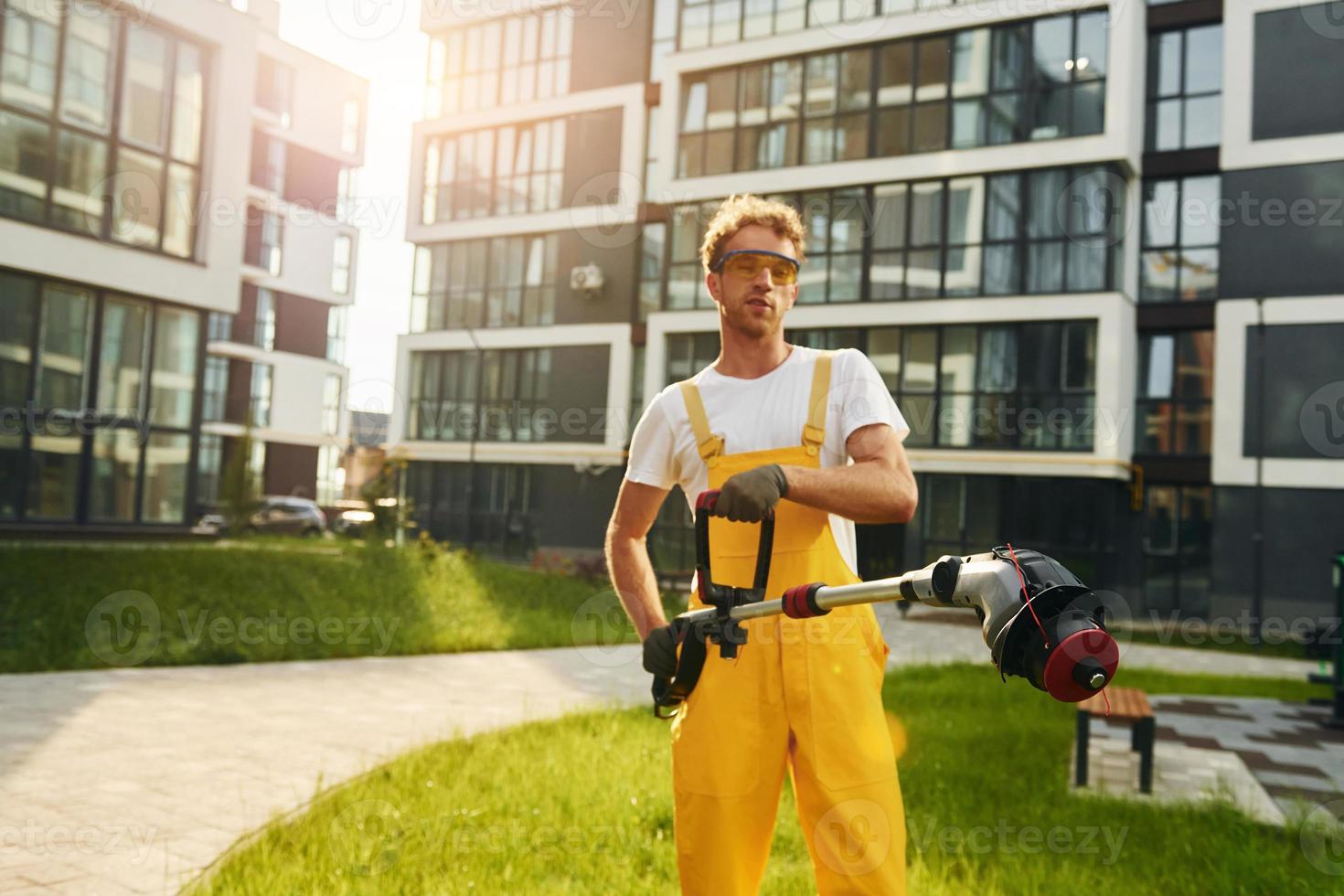 Man cut the grass with lawn mover outdoors in the yard photo