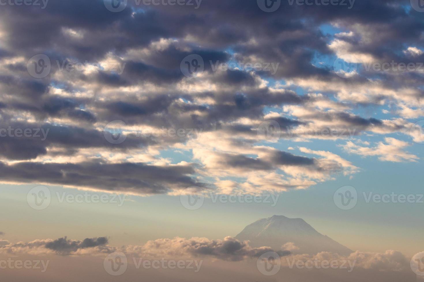 Cloudy faded Mt. Rainier above a foggy haze photo