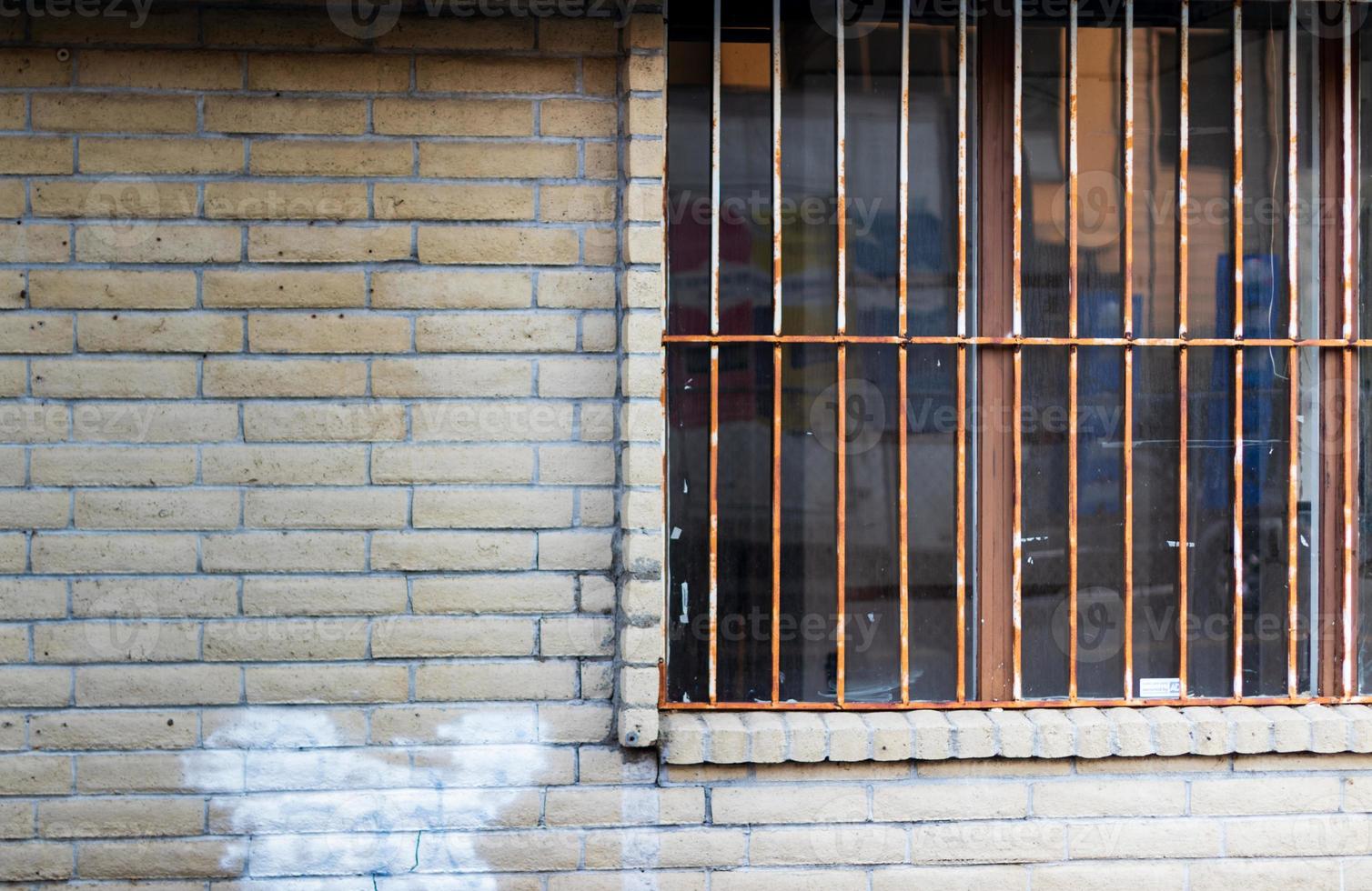 Old abandoned building window with rusty bars photo