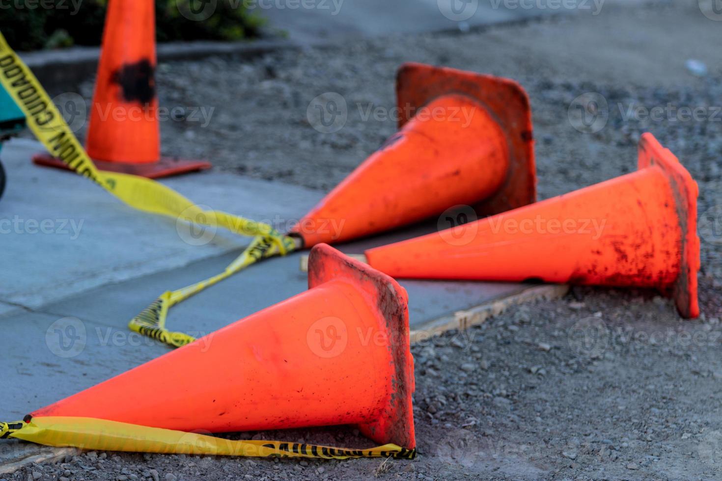 Fallen orange traffic cones and caution tape photo