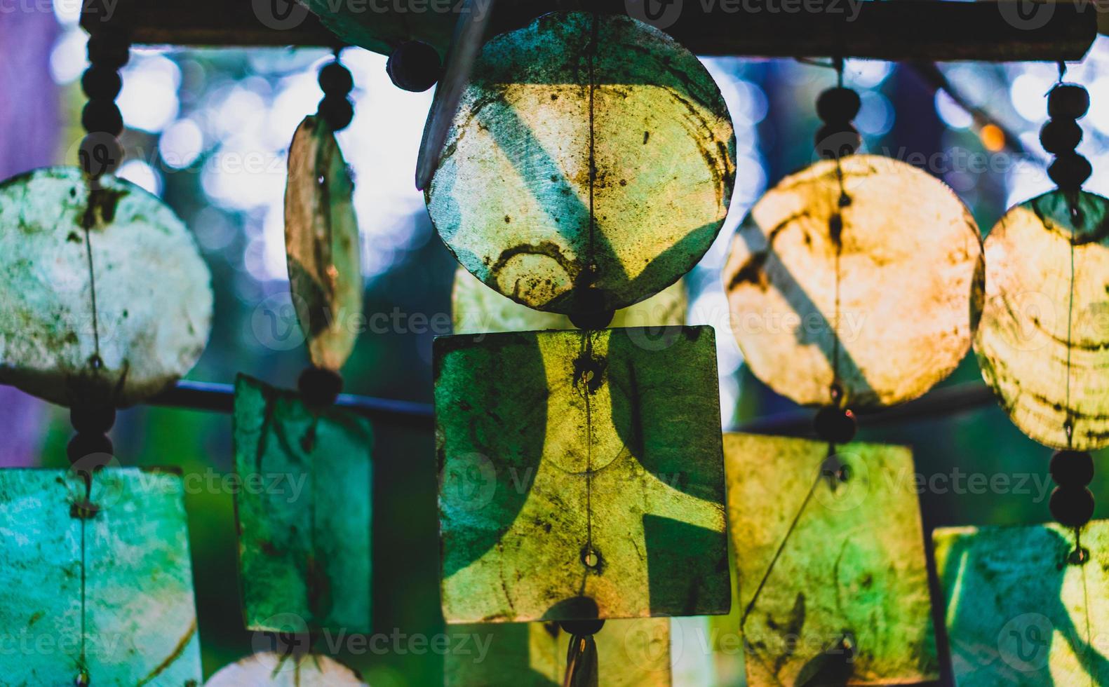 Glass wind chimes glowing in the evening light photo