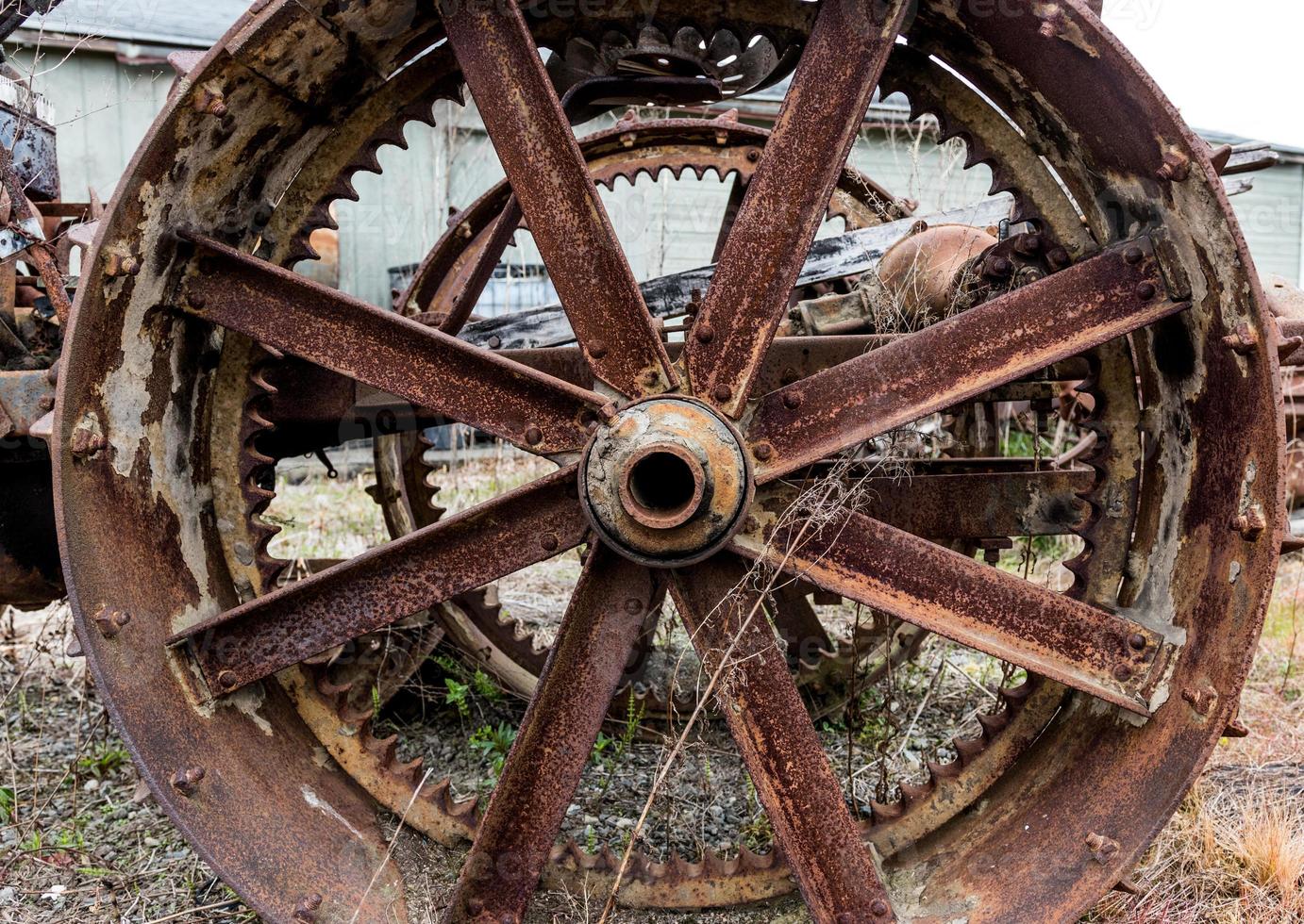 Vintage antique automotive tractor steel wheel spokes covered in rust and oxidation photo