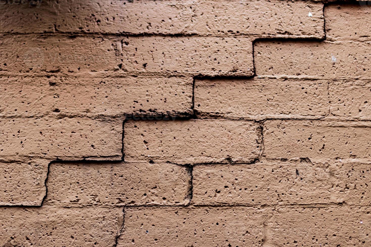 Old faded cracked brick wall photo