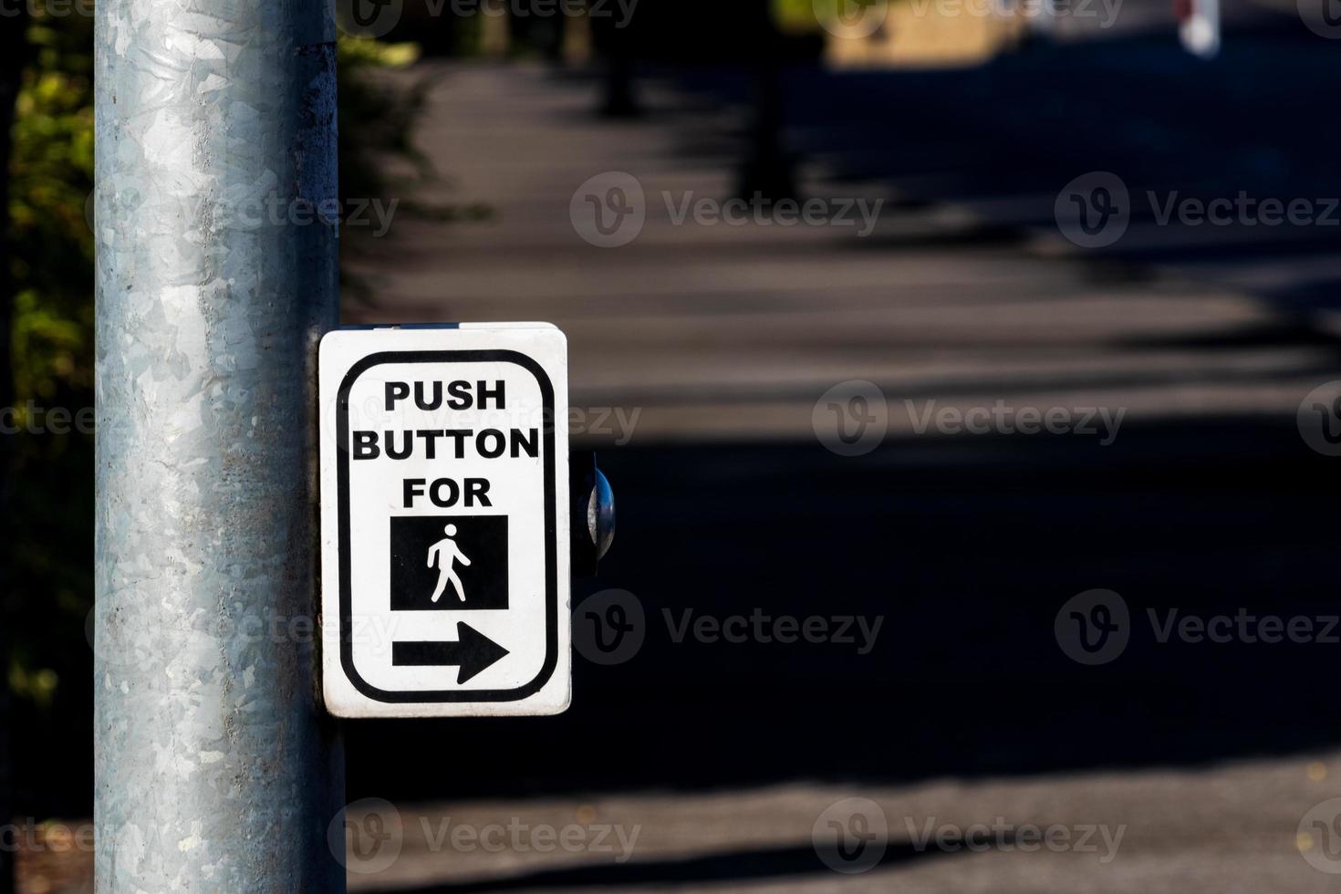 Crosswalk button mechanism on a steel post photo