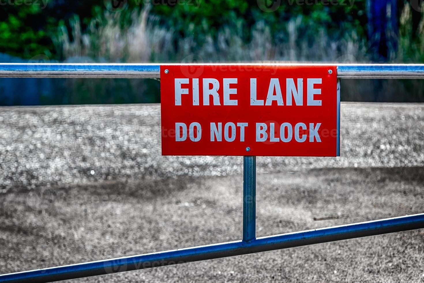 Fire lane do not block sign on a fence photo