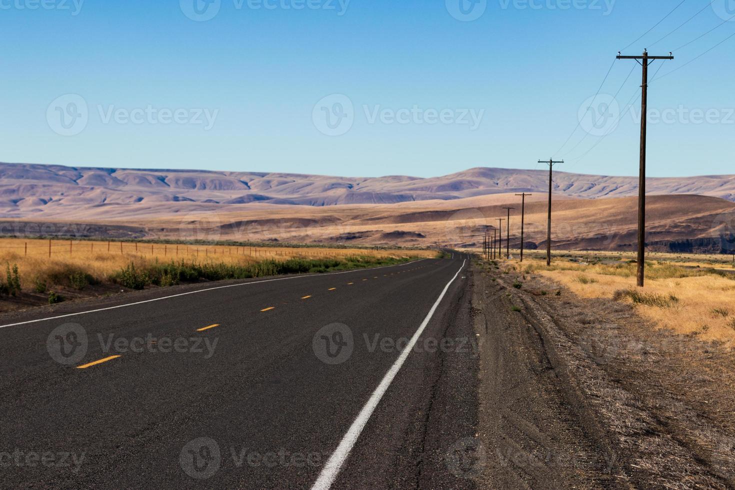 Palouse country highway going in to the distance in to rolling desert hills photo