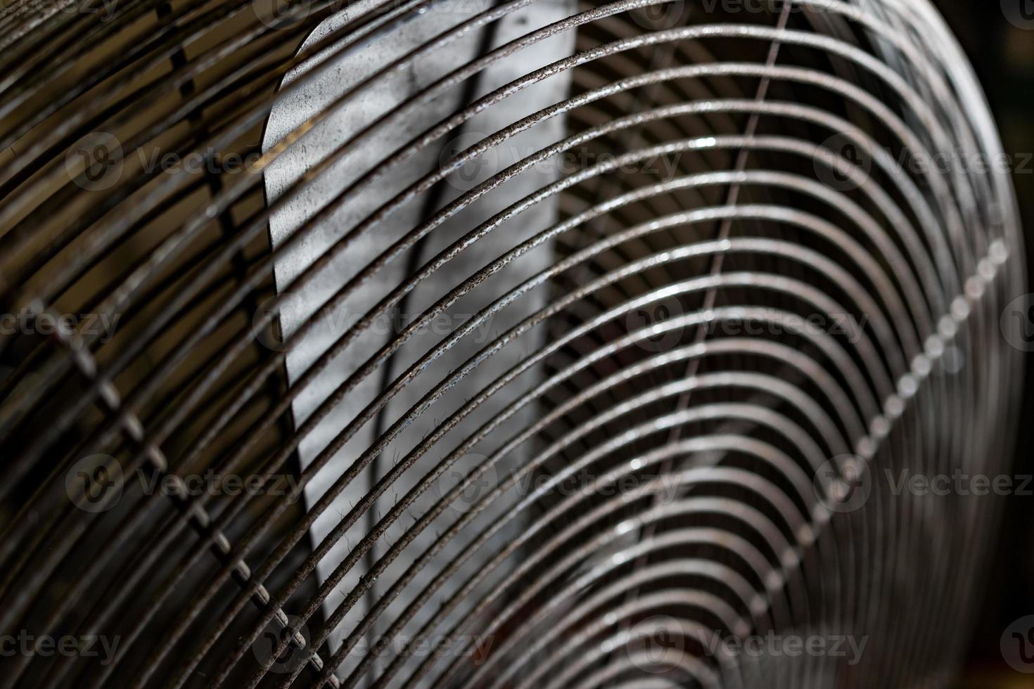 Dirty worn old rusty electric industrial fan photo
