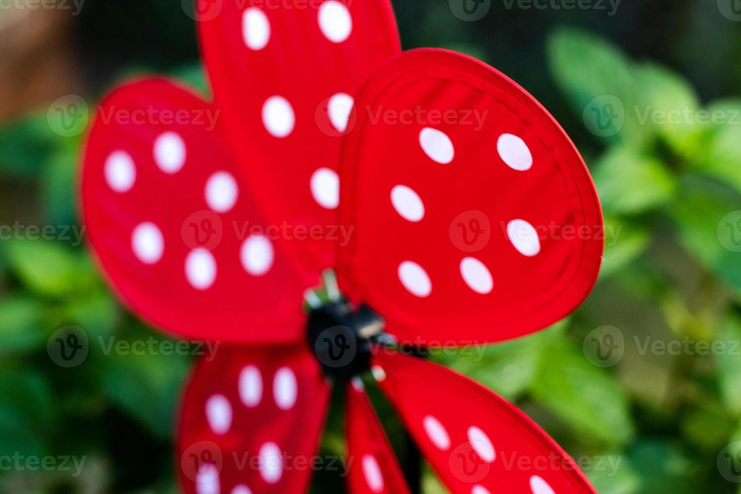 Garden whirligig abstract red with white ladybug dots photo