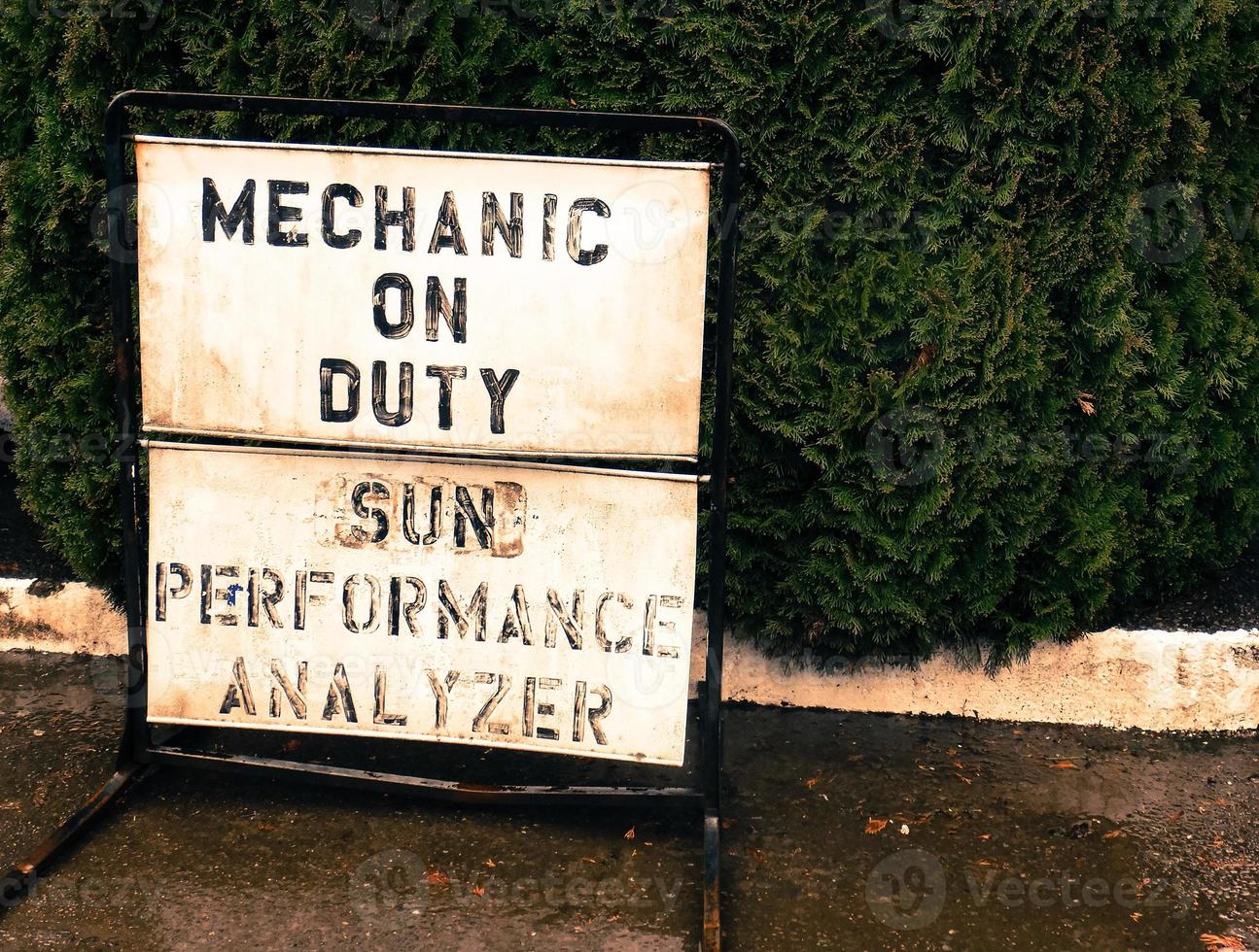 Small town mechanic on duty sign on a sidewalk photo