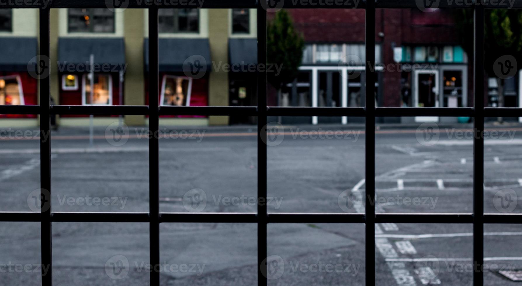 Wrought iron fence abstract with retail buildings blurred photo