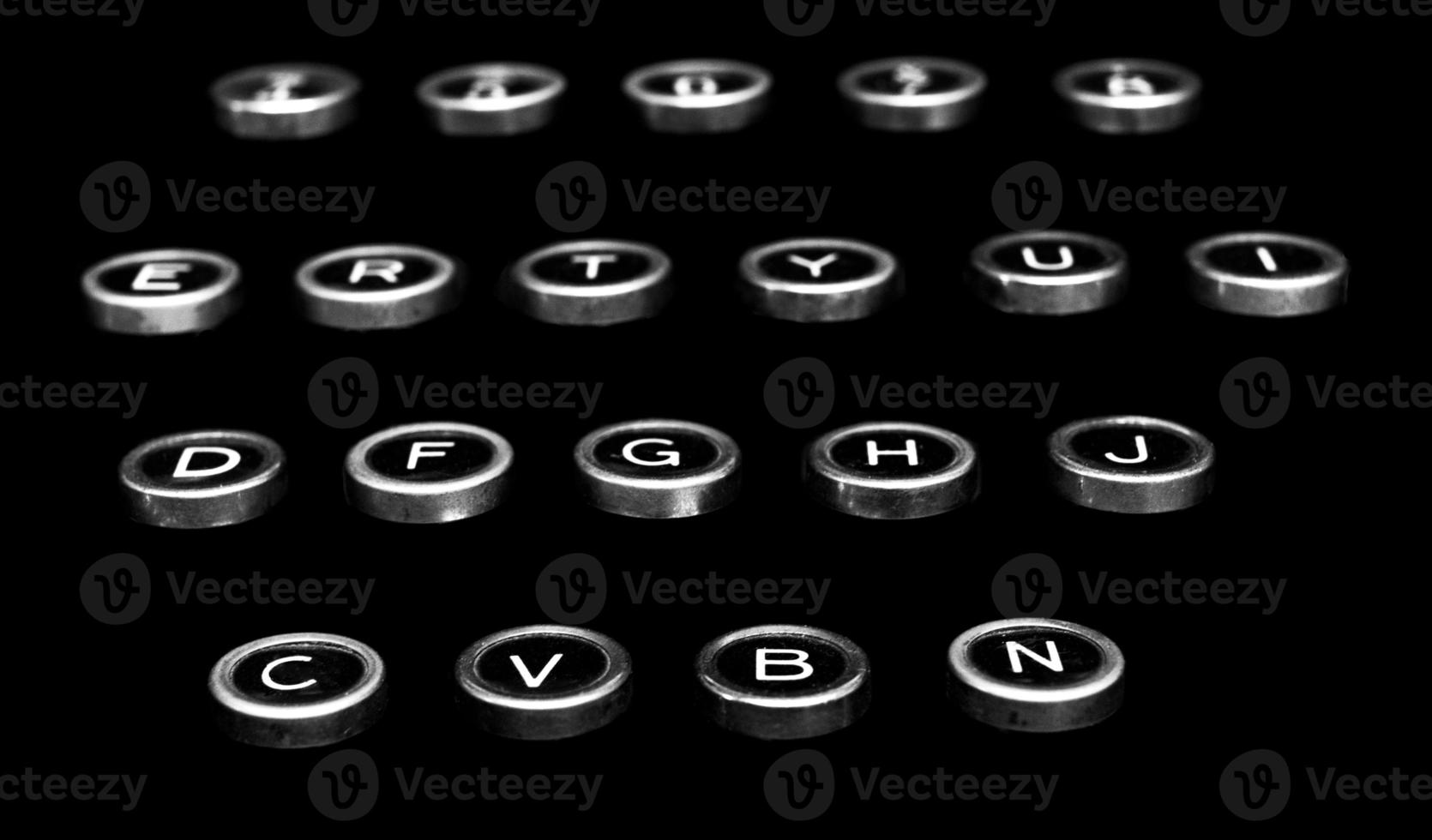 Vintage antique typewriter keys on a black background photo