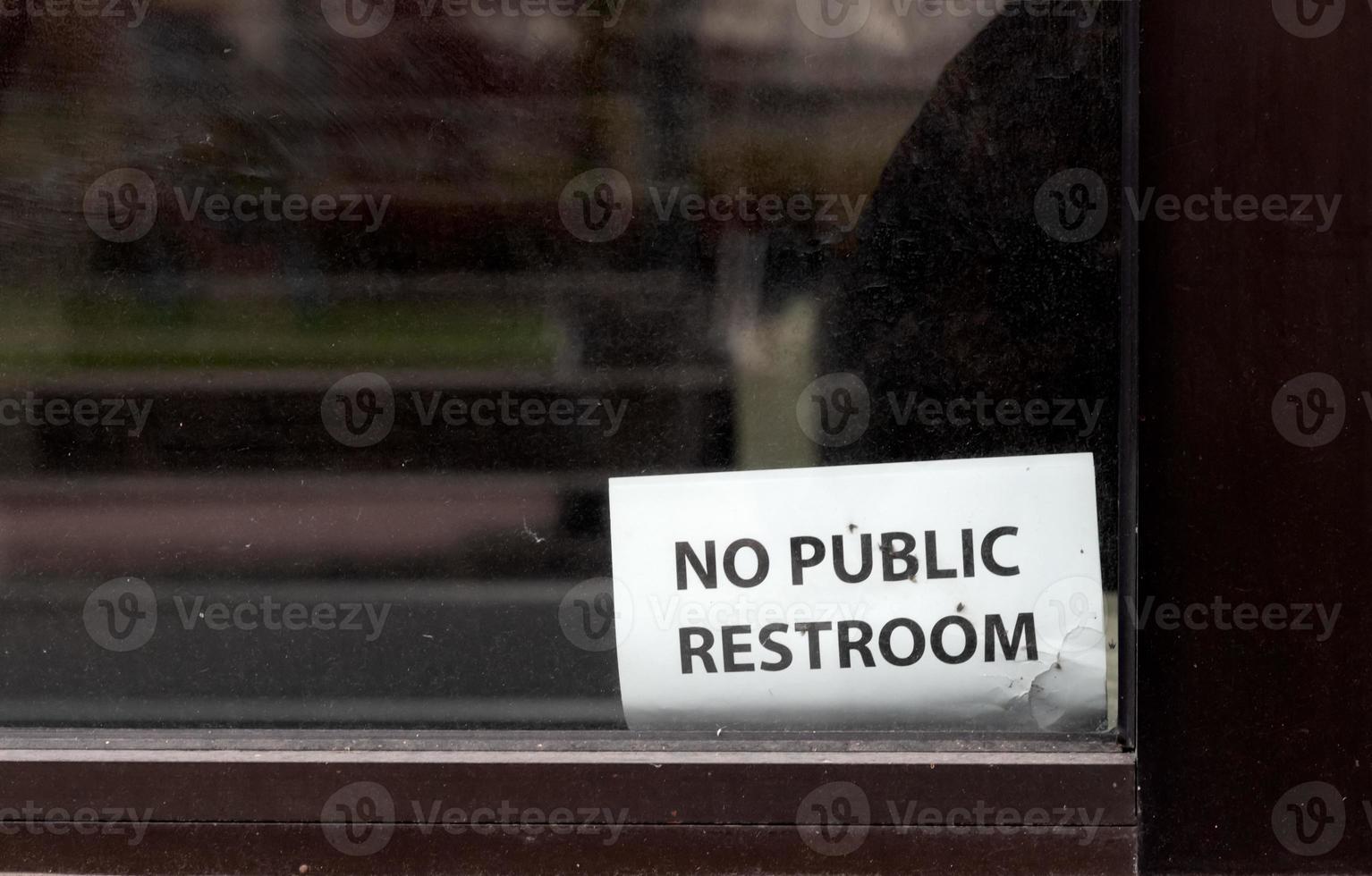 Abstract building window with no public restroom sign photo